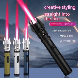Green, silver and blue jet torch lighters lit with pink-red flames, next to a large black one