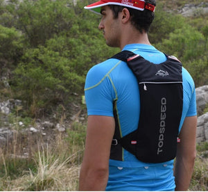 Runner wearing the black PureFlow hydration vest on a trail