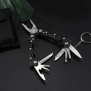 Small black Adventure Buddy open on a key ring, next to a black pouch