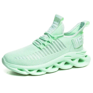 Mint green TrailHawk running shoe, side view, with a knit mesh top and wavy cut-out sole
