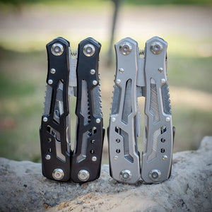Black and silver Adventure Buddy multi-tools standing closed on a rock