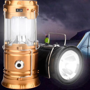 Gold lantern lit next to a black lantern shining as a flashlight at a campsite