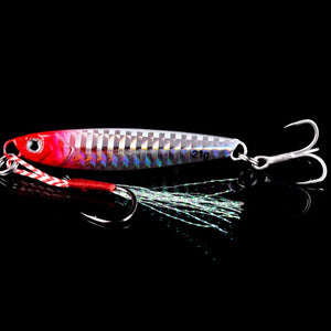 Pink and silver metal jig with a treble hook and feathered assist hook