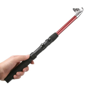 Hand holding a red telescopic fishing rod by the foam grip