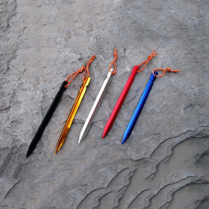 Five Y-beam tent stakes on a gray rock