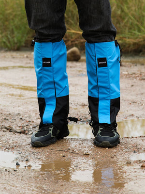 WeatherTrek Lite blue gaiters on hiking shoes standing in a muddy puddle