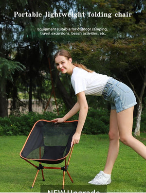 Woman unfolding the mesh moon chair on the grass