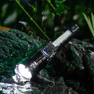 Flashlight glowing on a wet rock in the rain