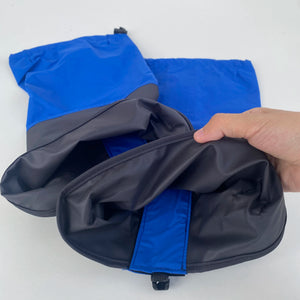 Blue and gray gaiters opened by hand to show the inside