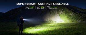 Hiker at night lighting a green field with the flashlight