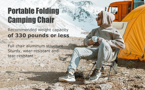 Man in a high back camping chair by his tent