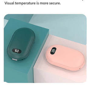 Green and pink hand warmers lying flat, heat number visible on the screen