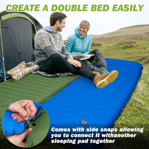 Two pads snapped together into one wide bed, green and blue, with a couple sitting on it