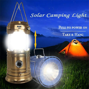 Gold lantern pulled open and lit, next to a blue lantern shining as a flashlight by a tent