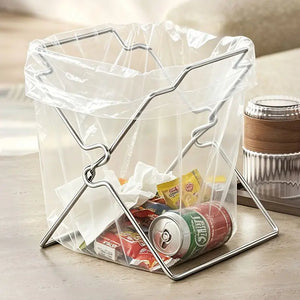 Steel bag holder filled with a soda can, snack wrappers and tissue on a counter