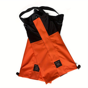 Orange and black gaiters folded flat with the straps showing