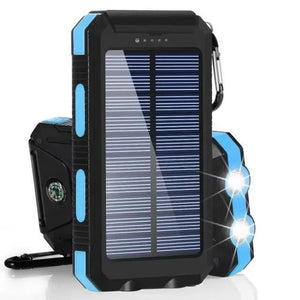 Blue TrailCell solar power bank with dual flashlights lit and compass on back
