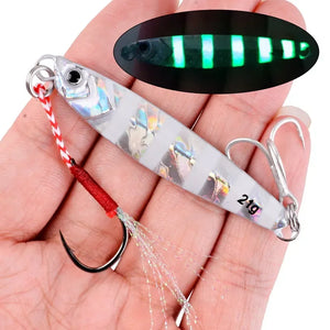 Striped silver 21 g metal jig in a hand, with an inset of it glowing