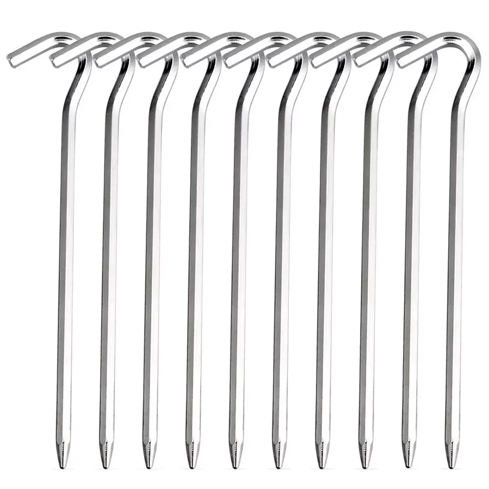 Silver GripHook aluminum hook stakes at a campsite, one holding a tent guy line while a camper taps another in with a mallet