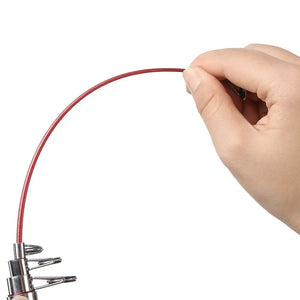 Hand bending the tip of a red fiberglass telescopic fishing rod