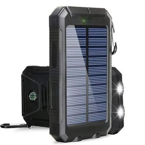 All-black TrailCell solar power bank with dual flashlights lit and compass on back