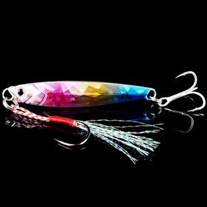 Pink holographic metal jig with a treble hook and feathered assist hook