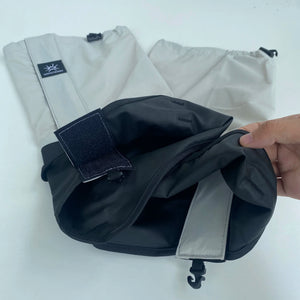 Light gray gaiter opened to show the hook-and-loop flap and black lower panel