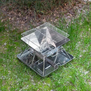 TrailBlaze folding grill set up on grass