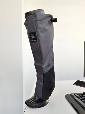 Gray and black gaiter on a leg form, drawcord toggle at the top