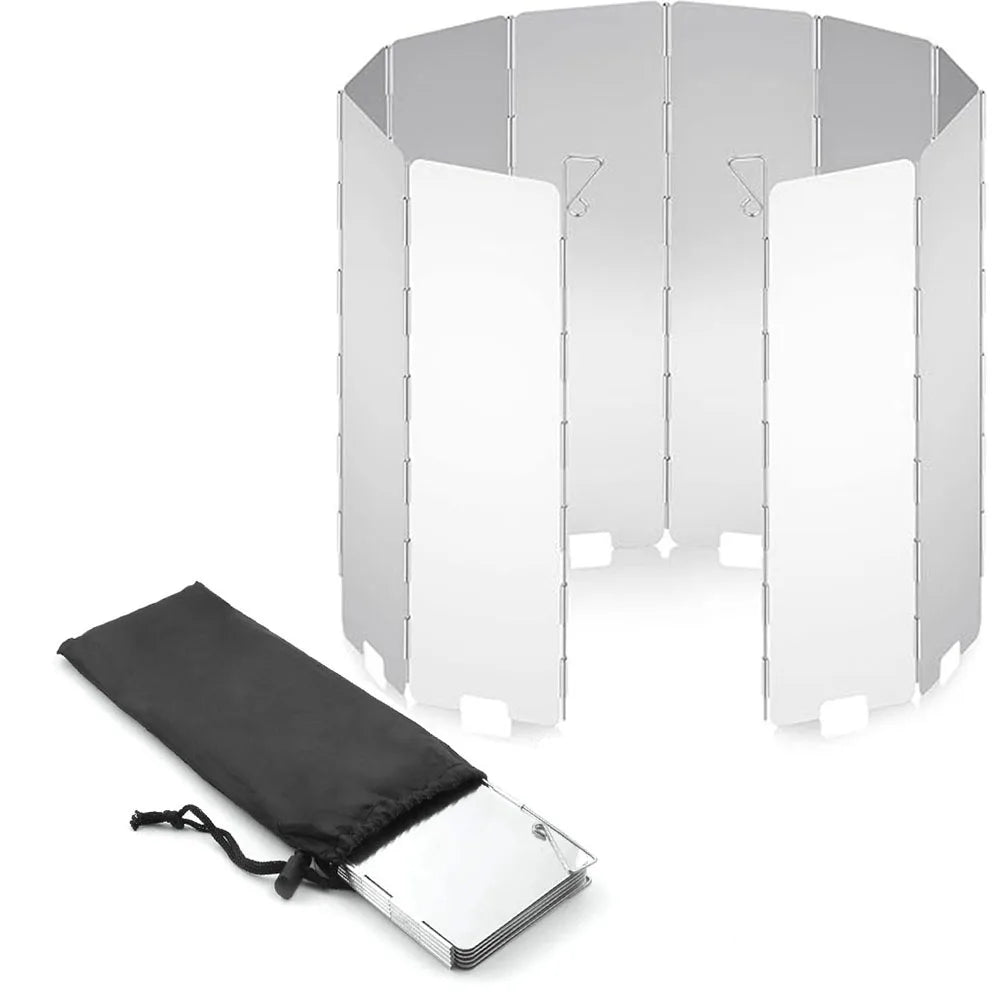 Folding aluminum camping stove windshield set up around a burner outdoors