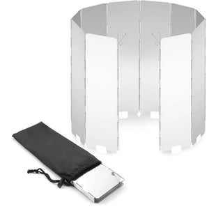 Folding aluminum camping stove windshield set up around a burner outdoors