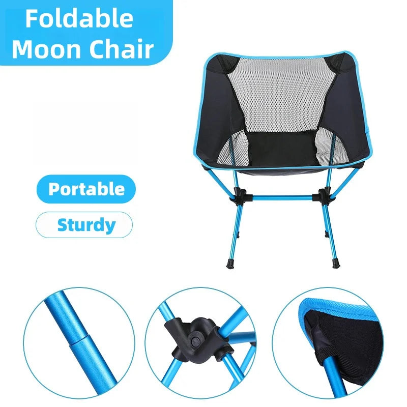 Mesh moon camping chair with orange trim by a lantern
