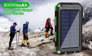Green TrailCell solar power bank next to hikers on a snowy mountain