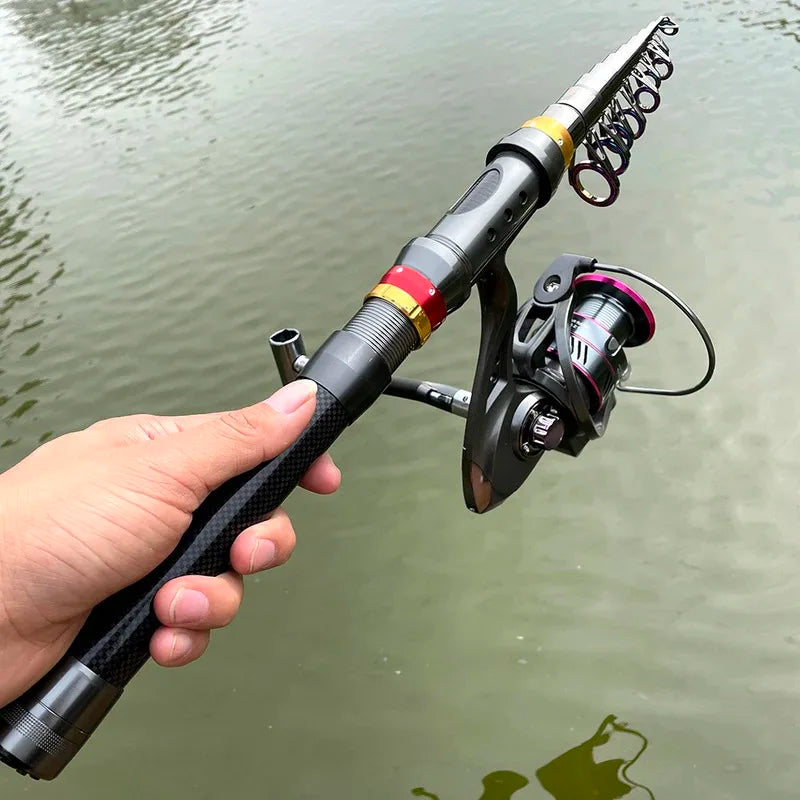 Two friends surf fishing on the beach with a telescopic rod and reel combo bent with a fish on