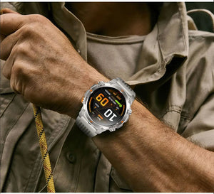 Man in khaki shirt holding a rope, wearing a silver smartwatch with grey band