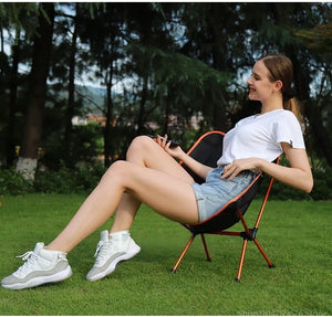 Woman leaning back in a mesh moon chair