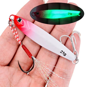 Red and white 21 g metal jig in a hand, with an inset of the jig glowing