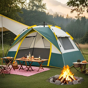 Dark green and beige pop-up tent at a campsite with a table and campfire