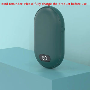 Green hand warmer on a blue block with a reminder to fully charge it before first use