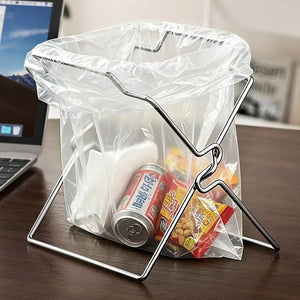 Close view of steel bag holder with can and snacks on a desk by a laptop