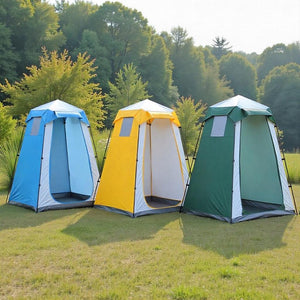 Blue, yellow and green privacy tents side by side on a grassy field