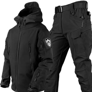 TrailShell hooded jacket in black with arm patch and zip pockets, shown with black cargo pants