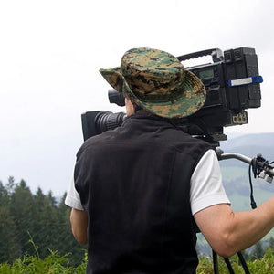 Person filming a green valley while wearing a digital woodland camo TactShield sun hat
