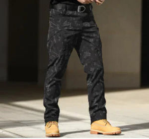 Dark camo cargo pants worn with tan boots, front view