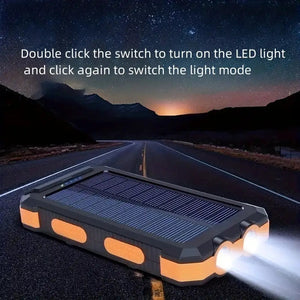 Solar power bank with orange trim on a night road, two flashlights on, with light-mode text (older model)