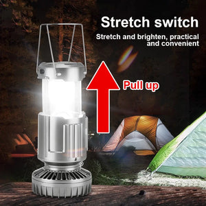 Silver lantern pulled up to turn on its light at a campsite, arrow showing pull up