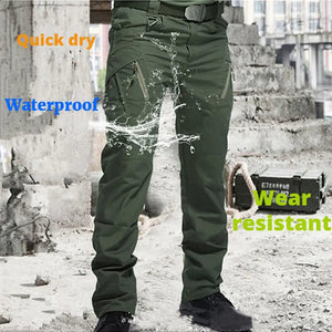 Green cargo pants with water splashing on them and the words quick dry, waterproof, wear resistant