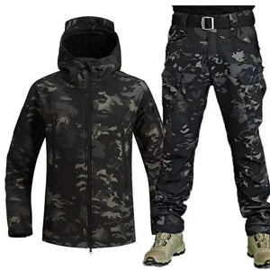 TrailShell hooded jacket in black camo shown with black camo cargo pants and tan boots