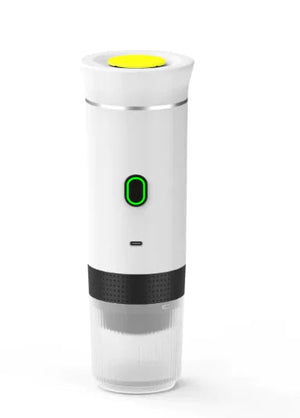 White NomadBarista portable espresso maker with a green power light and clear cup on the bottom