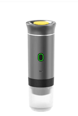 Grey NomadBarista portable espresso maker with a green power light and clear cup on the bottom
